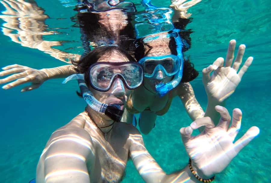 Matemwe: Mnemba Island Dolphin & Snorkeling Boat Trip - Sandbank swimming, fruit, and time on the dhow